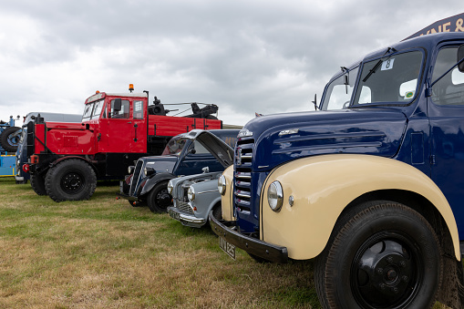 West Bay.Dorset.United Kingdom.June 12th 2022.A row of restored vintage vans and trucks are on display at the west Bay vintage rally