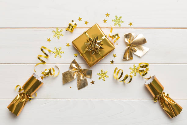 istock Christmas crackers with shiny confetti on color background, top view, copy space 1418278750