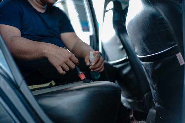 istock Man cleaning leather car seat 1418278913