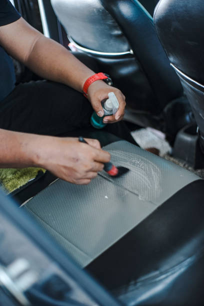 istock Man cleaning leather car seat 1418278931