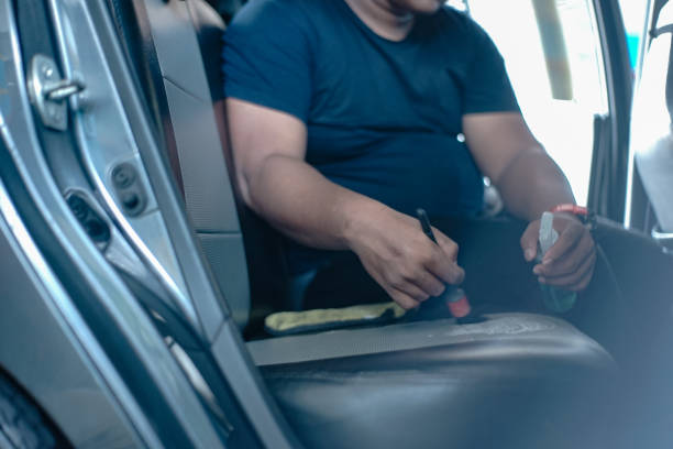 istock Man cleaning leather car seat 1418278932