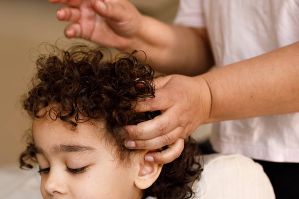 istock Mother fixing her son's hair 1418281729