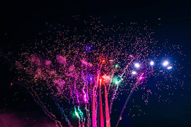Beautiful multi-colored fireworks against the background of the night sky. stock photo