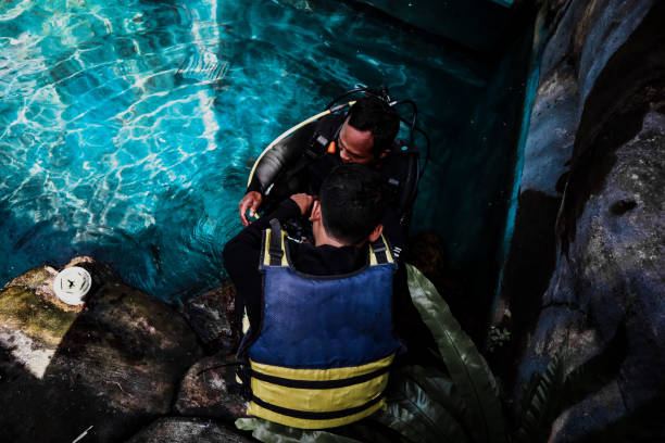 scuba diver cleans fish tank