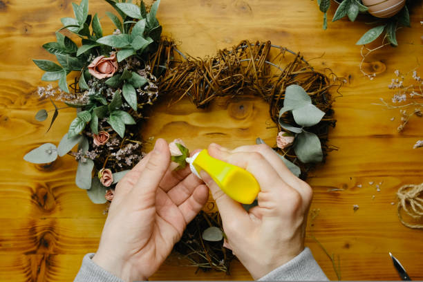 istock DIY spring home decor crafts. Hands makes spring floral wreath. 1418293242