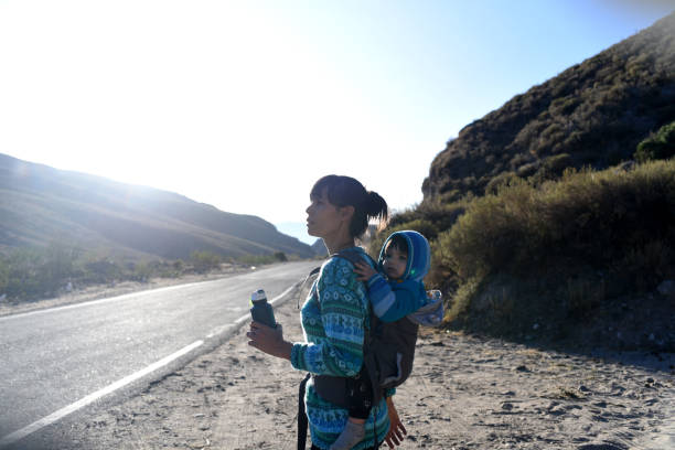 woman with child walking along road