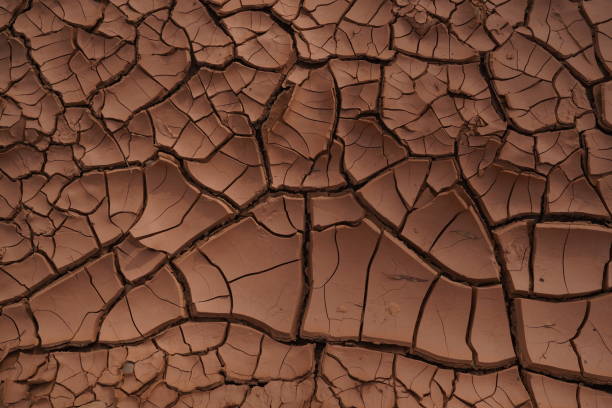 istock Background of dried red clay during a drought 1418296038