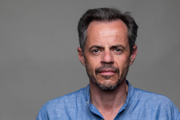 istock Serious man front mugshot on gray background 1418300137