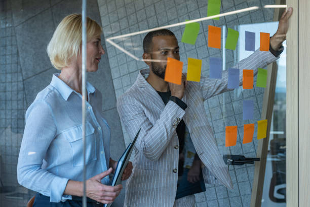 istock Colleagues discuss issues in a modern startup office and conference room. 1418303955