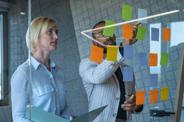 istock Colleagues discuss issues in a modern startup office and conference room. 1418303975
