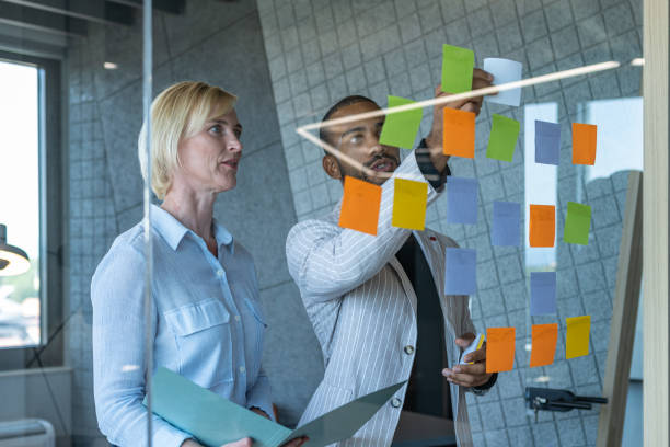 istock Colleagues discuss issues in a modern startup office and conference room. 1418303976