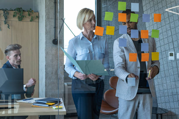 istock Colleagues discuss issues in a modern startup office and conference room. 1418303988