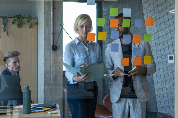 istock Colleagues discuss issues in a modern startup office and conference room. 1418303989