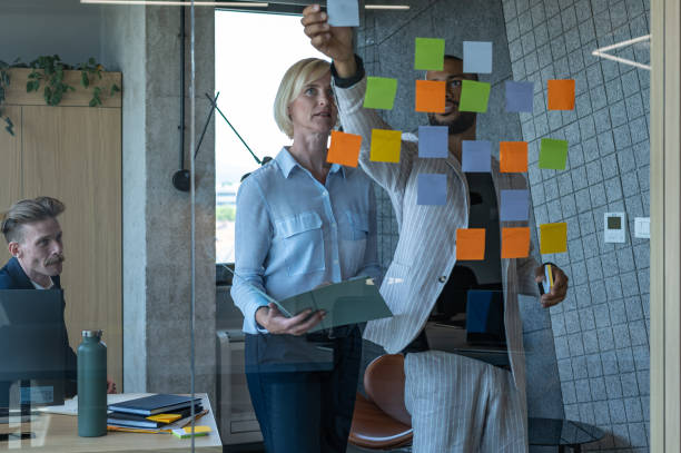 istock Colleagues discuss issues in a modern startup office and conference room. 1418303990