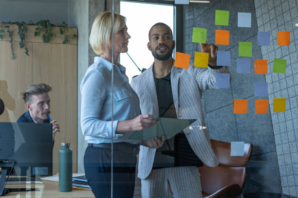 istock Colleagues discuss issues in a modern startup office and conference room. 1418304000