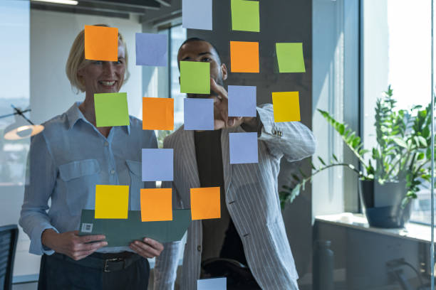 istock Colleagues discuss issues in a modern startup office and conference room. 1418304003