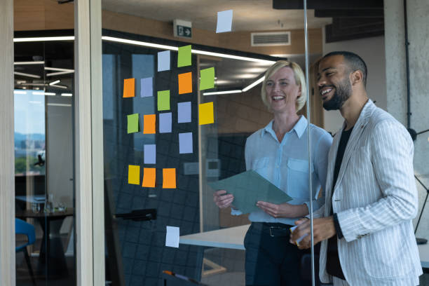 istock Colleagues discuss issues in a modern startup office and conference room. 1418304022