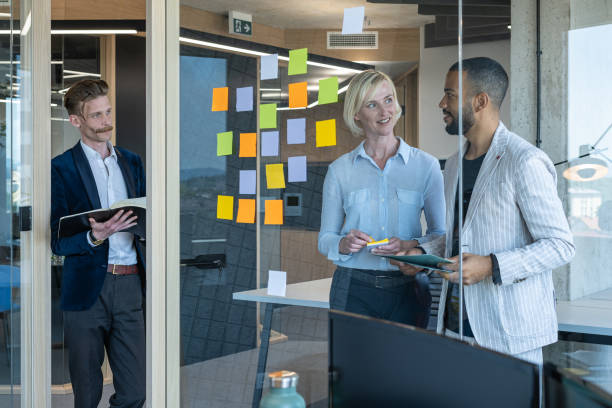 istock Colleagues discuss issues in a modern startup office and conference room. 1418304036