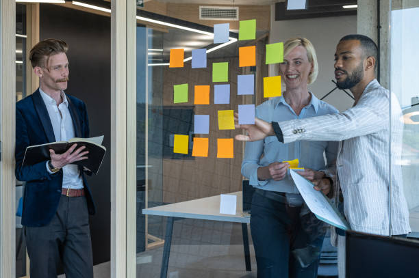 istock Colleagues discuss issues in a modern startup office and conference room. 1418304037