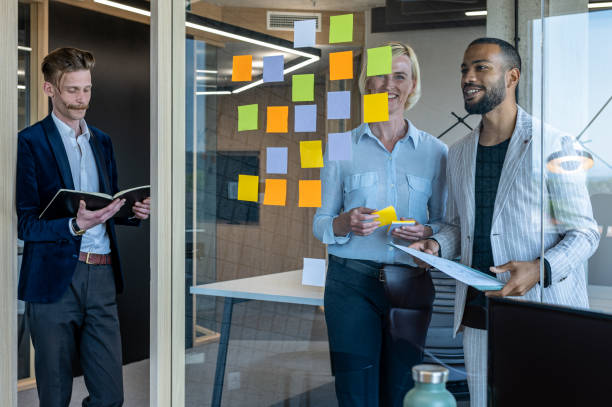 istock Colleagues discuss issues in a modern startup office and conference room. 1418304039
