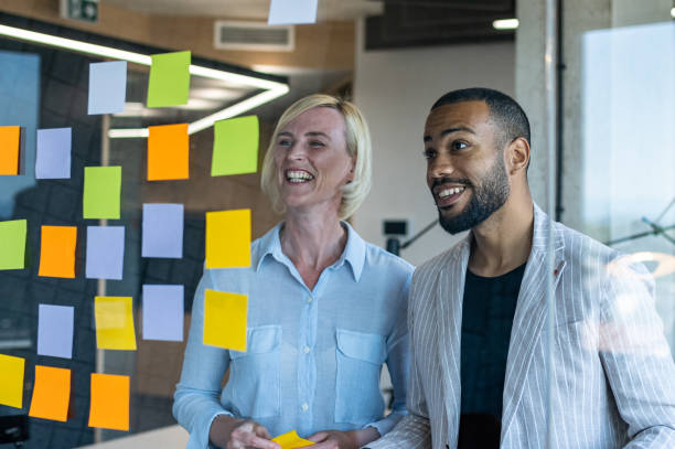 istock Colleagues discuss issues in a modern startup office and conference room. 1418304044