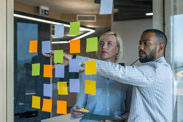 istock Colleagues discuss issues in a modern startup office and conference room. 1418304045