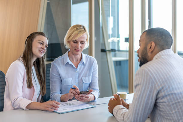 istock Colleagues discuss issues in a modern startup office and conference room. 1418304643