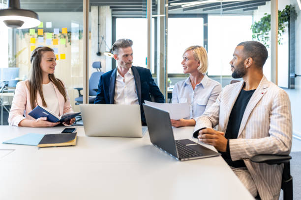 istock Colleagues discuss issues in a modern startup office and conference room. 1418304681