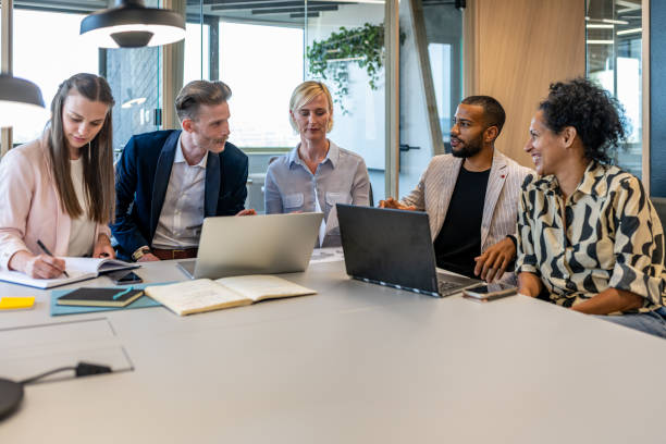 istock Colleagues discuss issues in a modern startup office and conference room. 1418304751