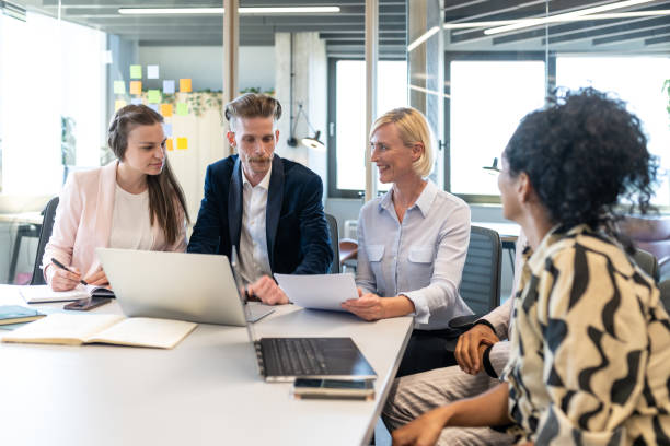 istock Colleagues discuss issues in a modern startup office and conference room. 1418304781