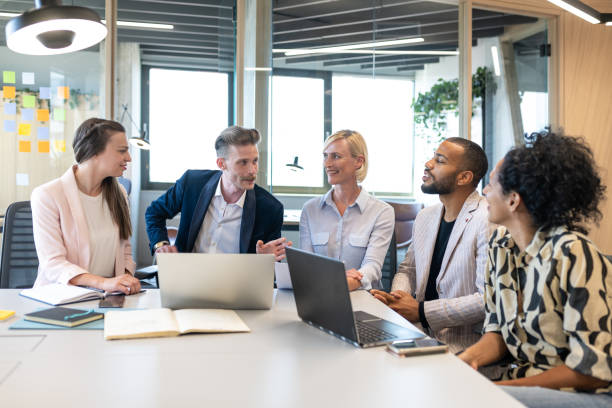 istock Colleagues discuss issues in a modern startup office and conference room. 1418304788