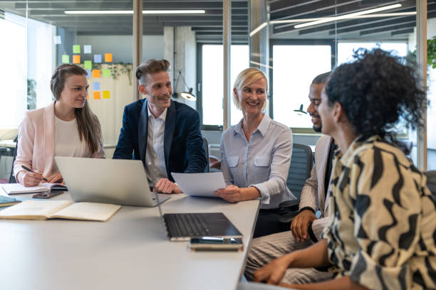 istock Colleagues discuss issues in a modern startup office and conference room. 1418304789