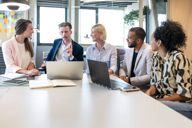 istock Colleagues discuss issues in a modern startup office and conference room. 1418304791