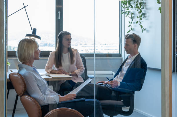 istock Colleagues discuss issues in a modern startup office and conference room. 1418304901