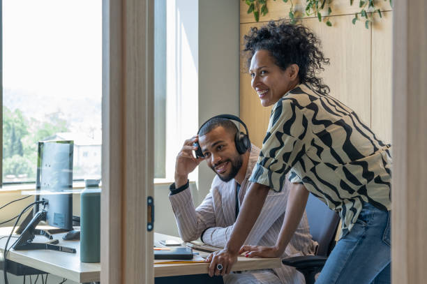 istock Colleagues discuss issues in a modern startup office and conference room. 1418304911