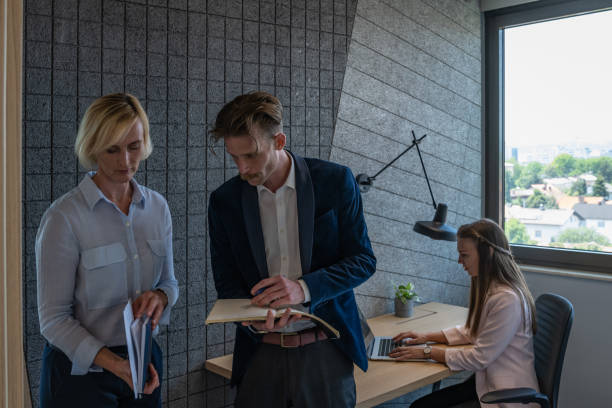 istock Colleagues discuss issues in a modern startup office and conference room. 1418304915