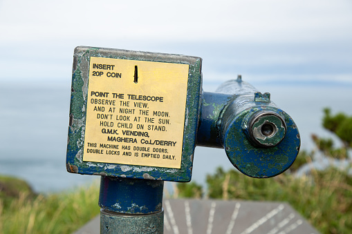 Ballintoy, County Antrim, Northern Ireland - Aug 30th, 2020: A vintage coin-operated telescope viewing Sheep Island