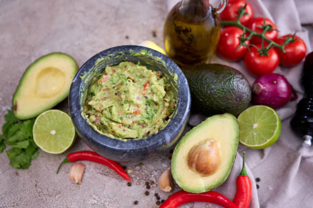 istock freshly made guacamole in marble mortar with ingredients on grey concrete background 1418317531