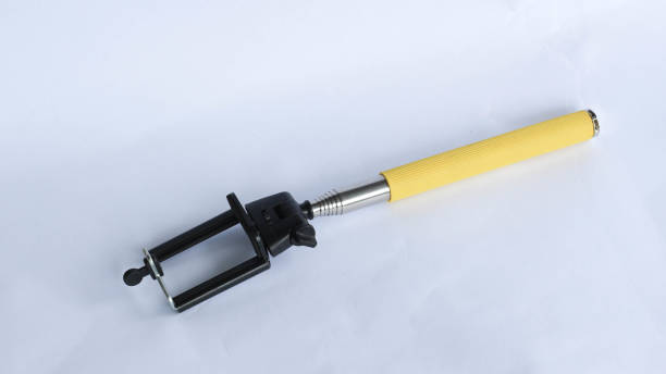 istock Self-expandable selfie stick with clip at the end for storing smartphone isolated on white background 1418323300