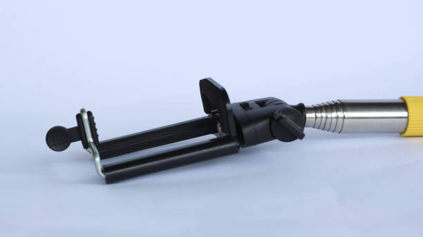 istock Self-expandable selfie stick with clip at the end for storing smartphone isolated on white background 1418323304