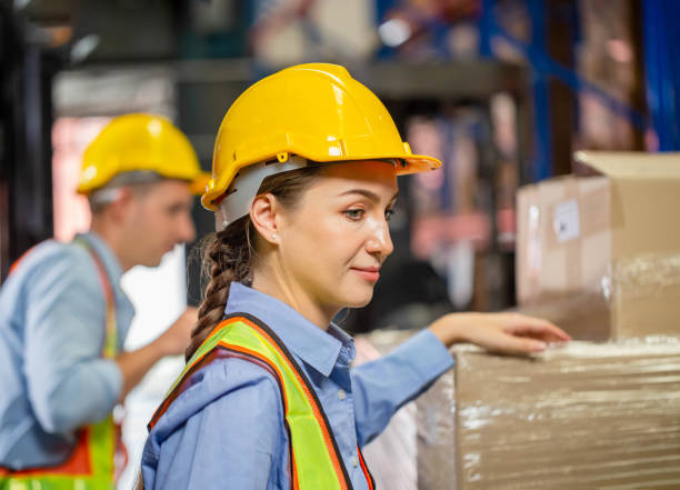 istock Female foreperson making plans with warehousemen, Manager and supervisor taking inventory in warehouse, Workers working in warehouse 1418329461