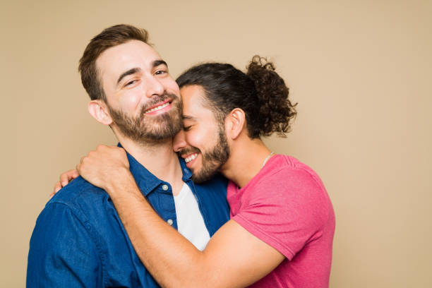 istock Smiling latin man embracing his happy boyfriend 1418334902