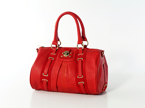 Red leather handbag on white background