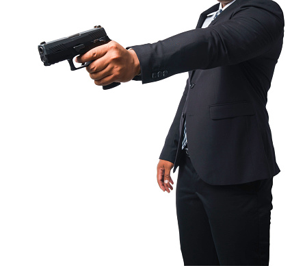 Template of a gunman wearing a black suit and holding a pistol isolated included with clipping path.