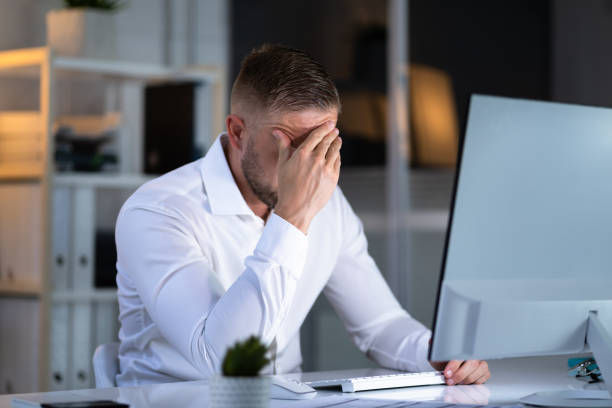 istock Stressful Business Man Working On Laptop 1418358480
