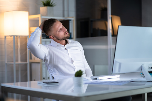 Man Stretching At Office Desk. Worker Stretch Workout