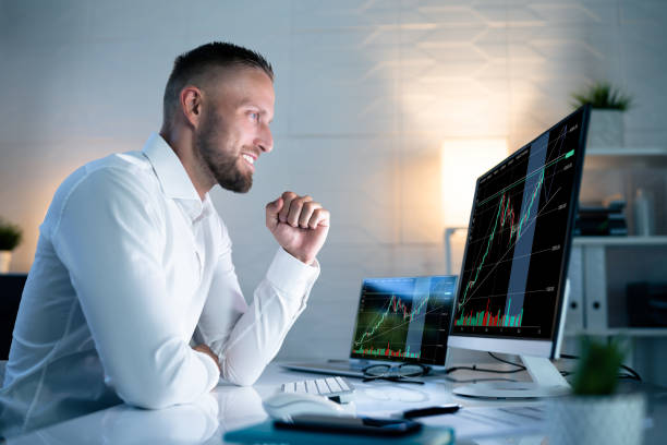 istock Successful Stock Market Trader Looking At Graphs 1418358511