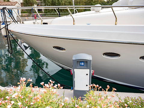 Charging station for boats, electrical outlets to charge ships in harbor. Electrical power sockets bollard point on pier near sea coast. Aspat Marina. Bodrum, Turkey. Close up