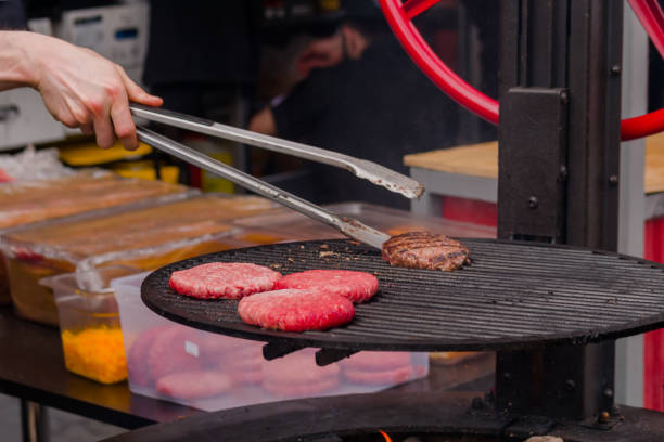istock Chef grilling meat cutlets for burgers - close up 1418364358