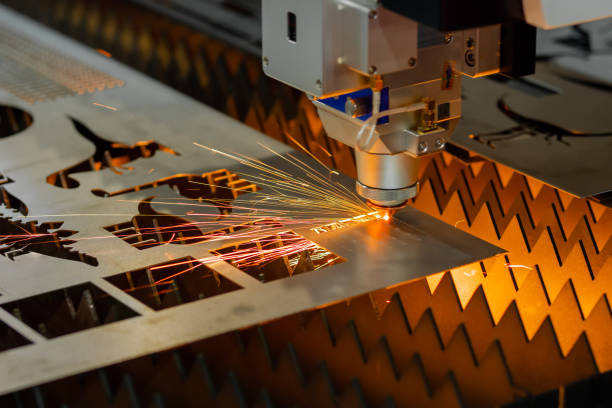 istock Laser cutting machine working with sheet metal with sparks 1418365484